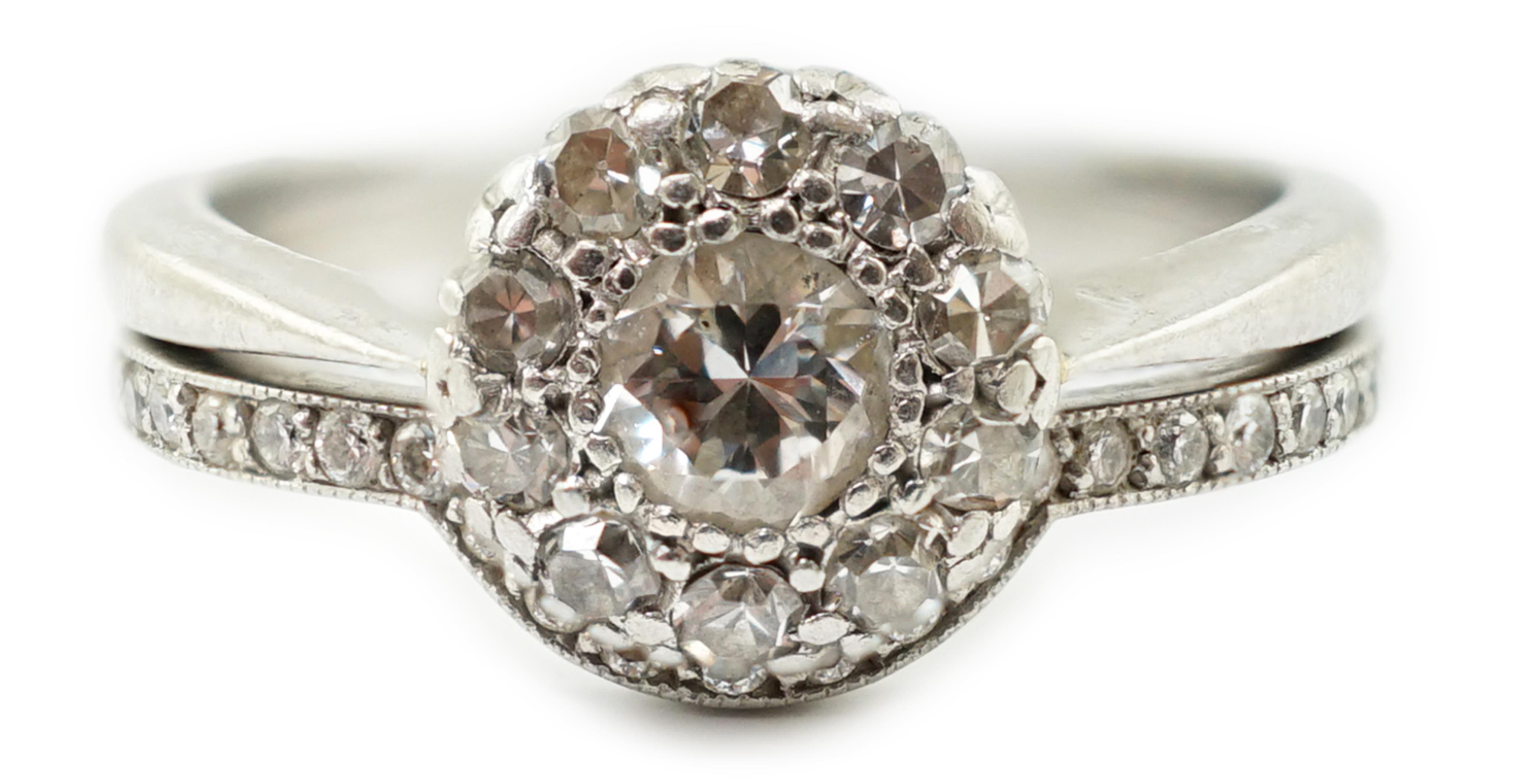 A mid 20th century and later platinum and diamond matched two piece wedding set